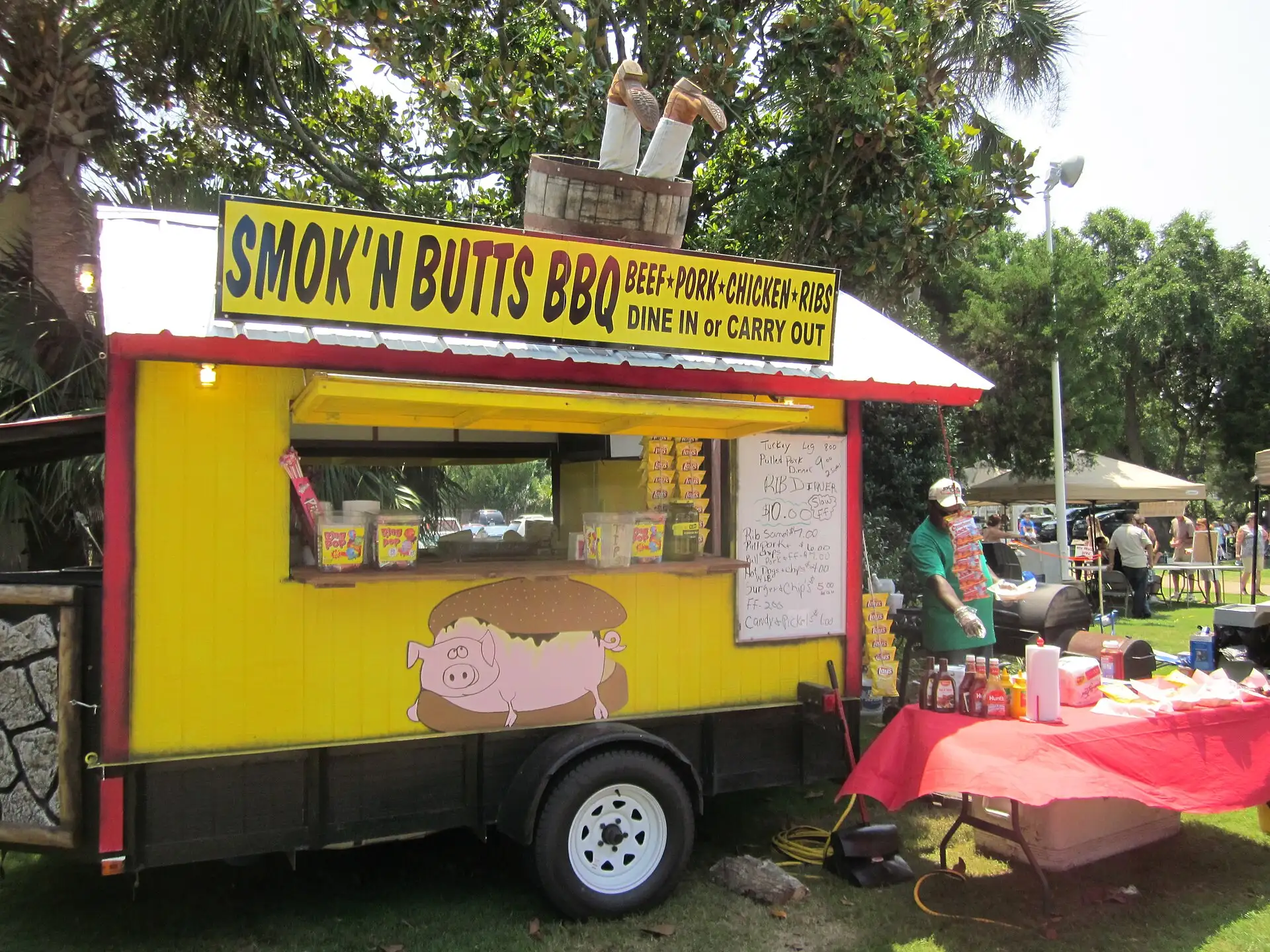 A barbecue vendor serves festivalgoers at a Latino festival at The Landing in Fort Walton Beach, Fla.