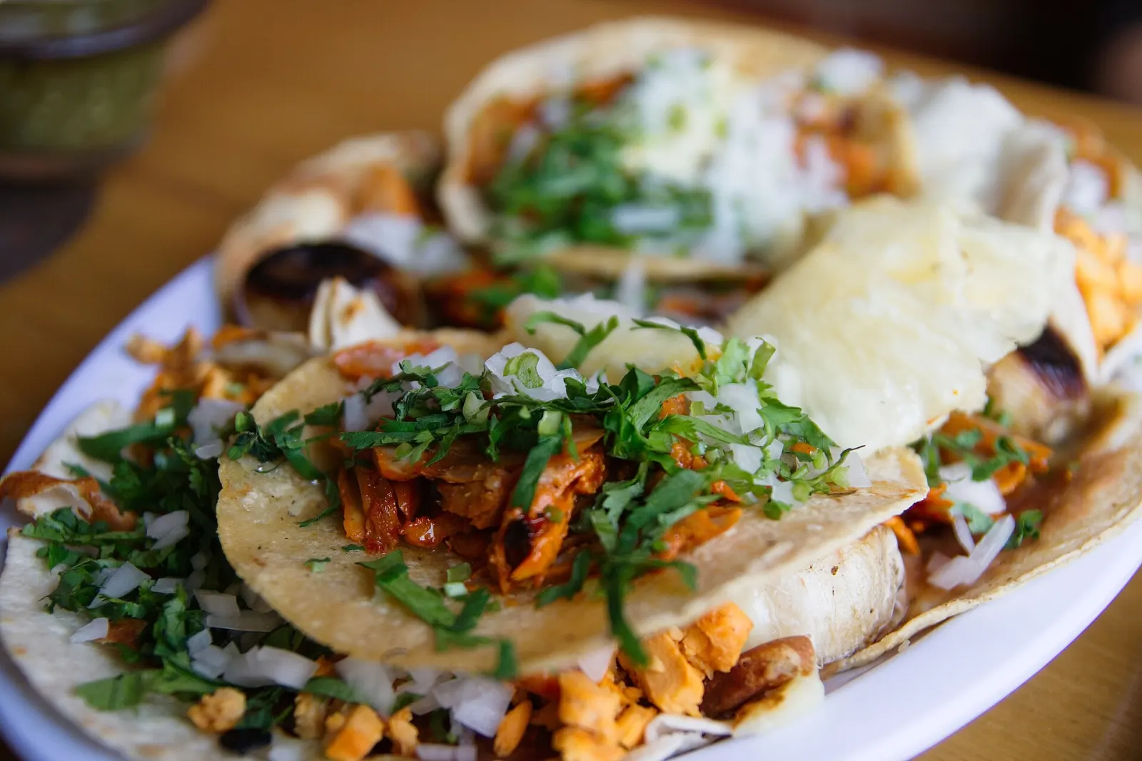 A plate of tacos al pastor with onion and cilantro. The photo was not taken in Wesley Chapel.