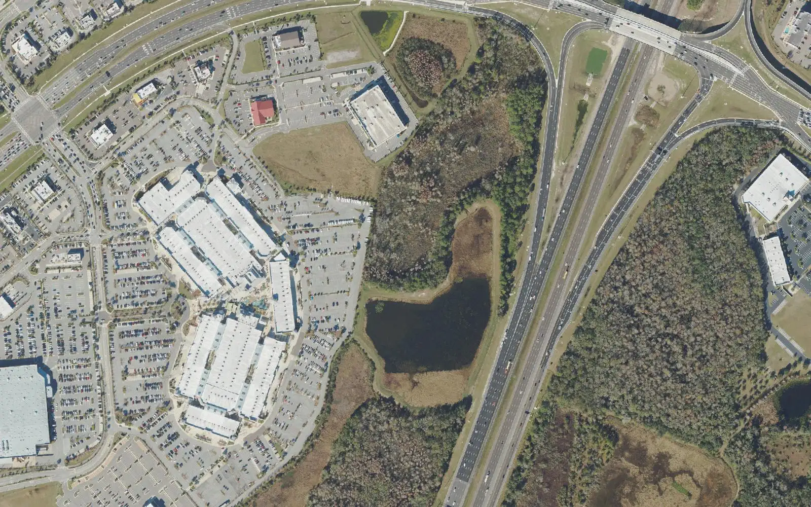 Tampa Premium Outlets and its parking lots at left, with the I-75 interchange at State Road 56 at right, in an aerial view of the Cypress Creek district.