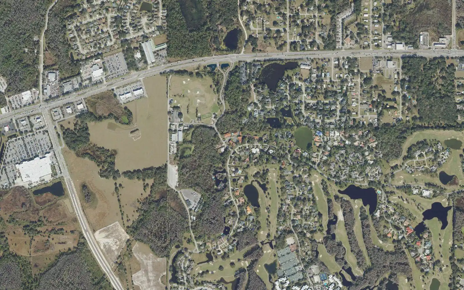 State Road 54 along the upper edge and the Saddlebrook Resort golf courses at lower right, in an aerial view of central Wesley Chapel.