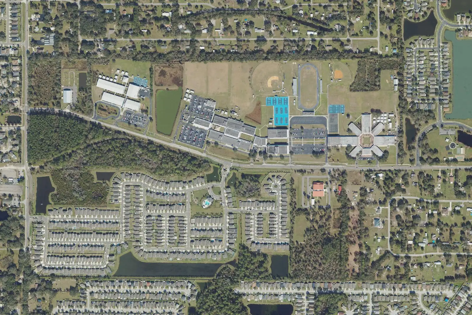 Wesley Chapel Elementary, Wesley Chapel High and Thomas E. Weightman Middle, left to right along Wells Road, with the neighborhoods around them, seen from the air.