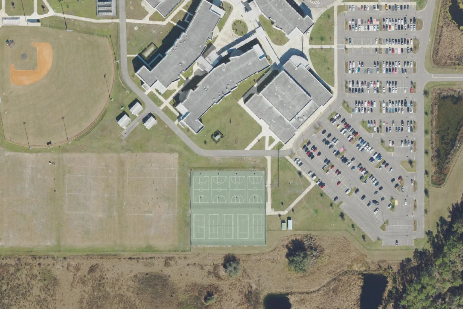 Cypress Creek High School's classroom buildings, ball fields and courts off Old Pasco Road, seen from the air.