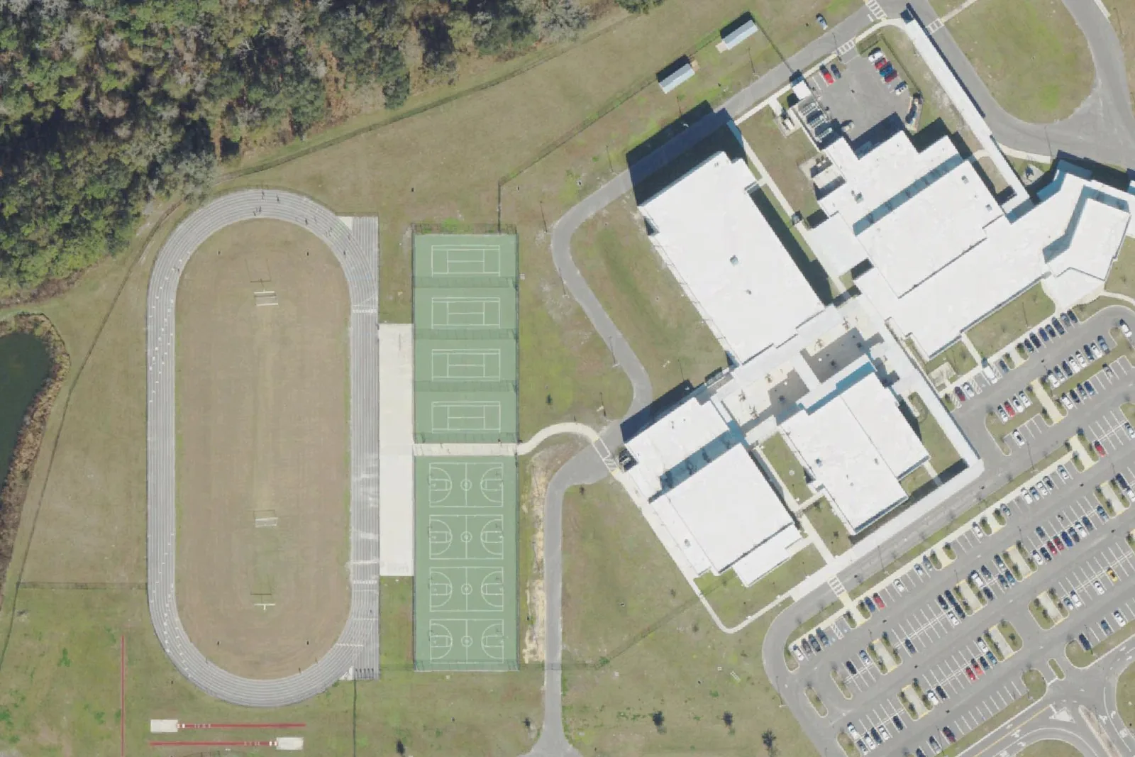 Cypress Creek Middle School's classroom building, track and fields off Old Pasco Road, seen from the air.