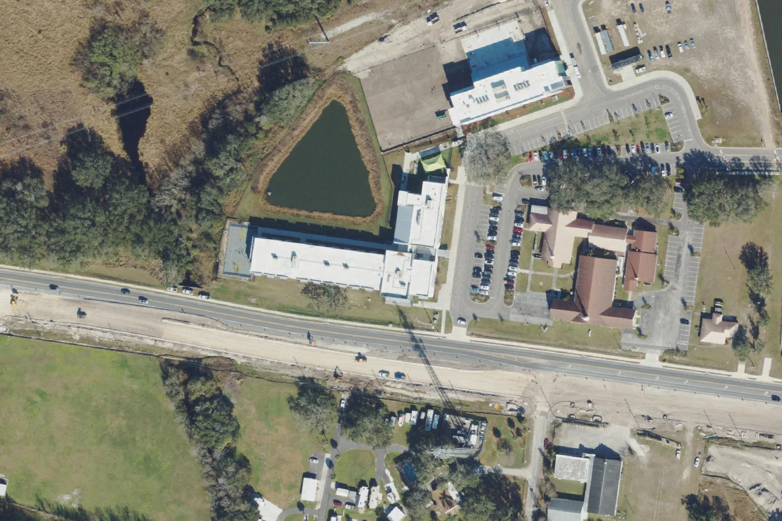Pinecrest Academy Wesley Chapel's round school building and parking lots off State Road 54, seen from the air.