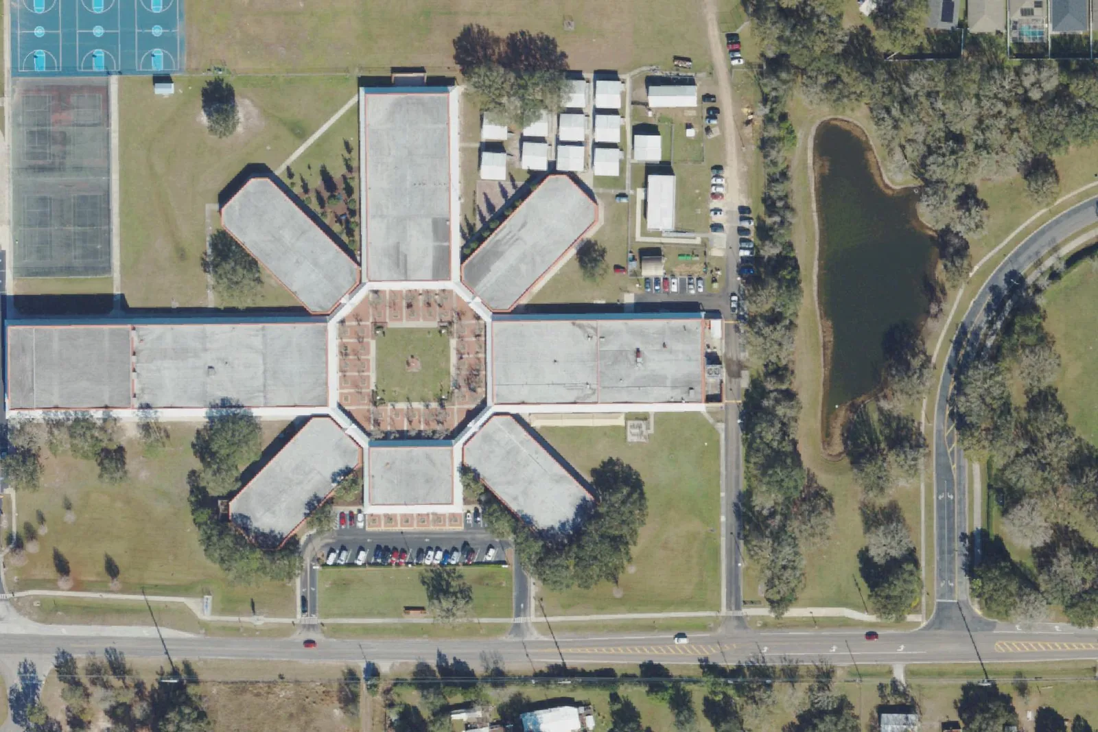 Thomas E. Weightman Middle School's six-winged classroom building, courts and fields on Wells Road in Wesley Chapel, seen from the air.