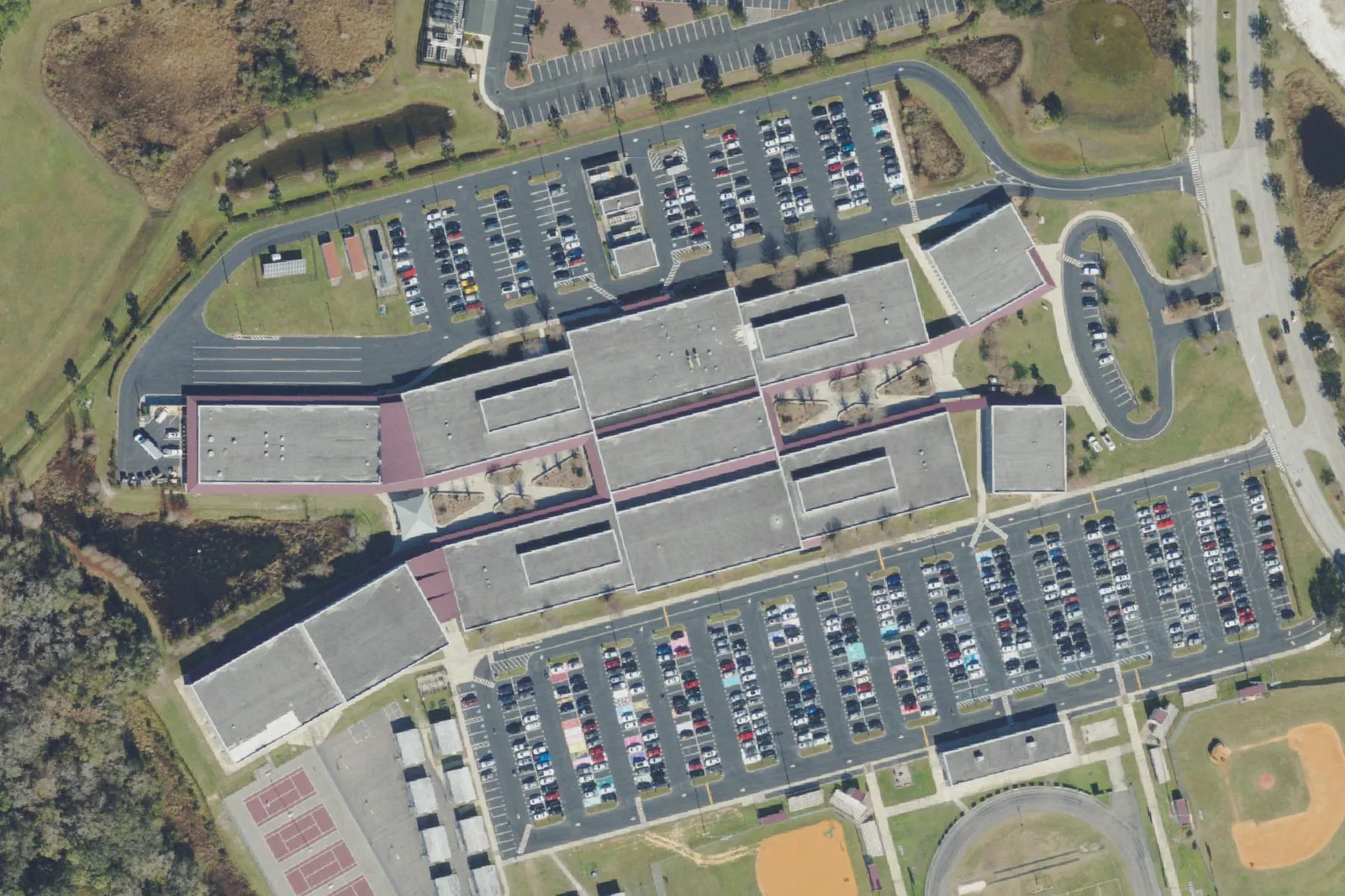 Wiregrass Ranch High School's buildings, parking lots and courts on Mansfield Boulevard in Wesley Chapel, seen from the air.