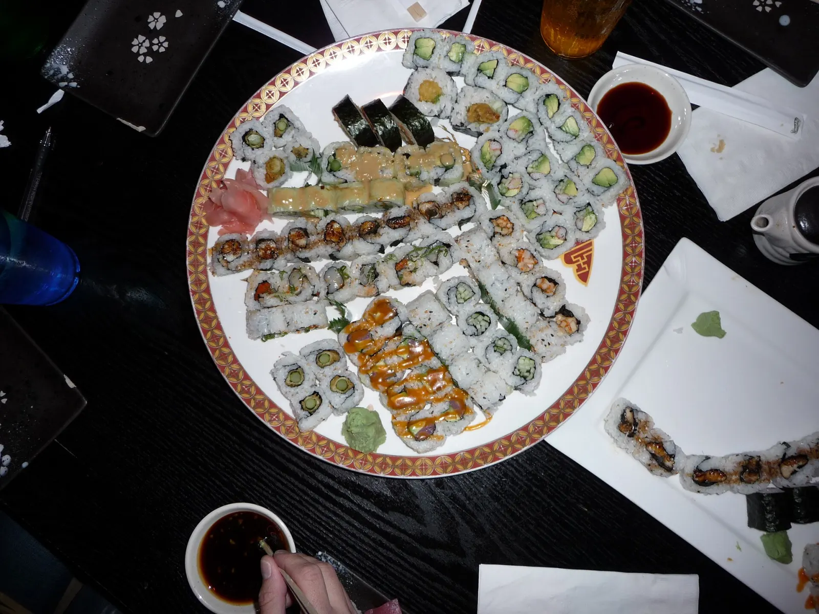 A platter of assorted sushi rolls with soy sauce. The photo was not taken in Wesley Chapel.