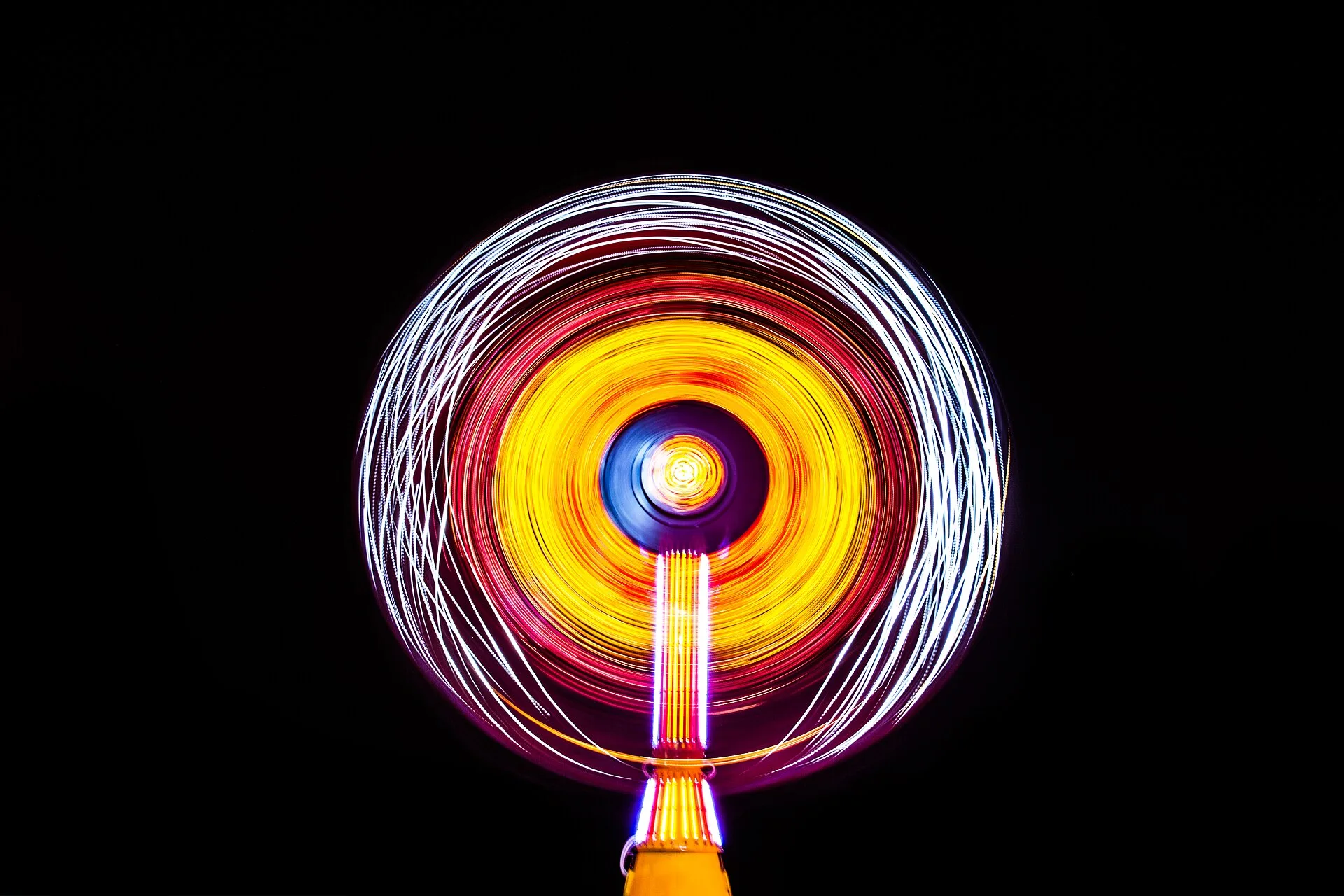 A spinning carnival ride lit up at night at a carnival in Cocoa Beach, Fla.