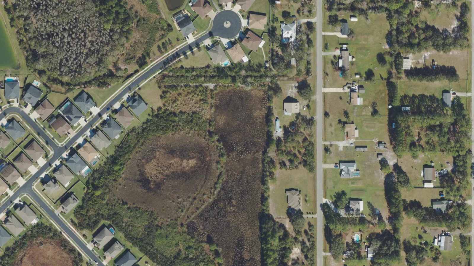 Subdivision homes and larger rural lots in eastern Wesley Chapel, in an aerial view.