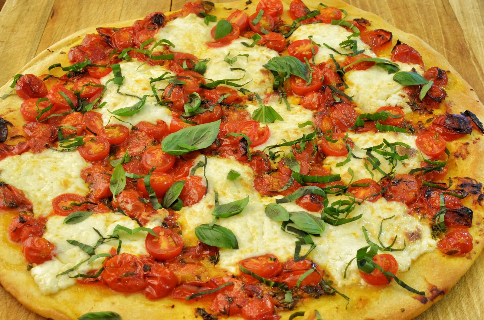 A margherita pizza with cherry tomatoes and basil. The photo was not taken at a Wesley Chapel restaurant.